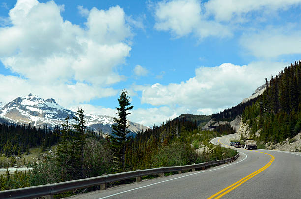 istock lonely road running through die Rocky Mountains, Canada BC 507431683