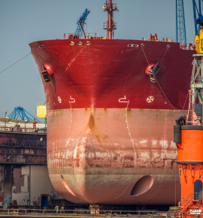 Huge ocean vessel with bulbous bow of a huge ocean vessel in a drydock at Hamburg port.  