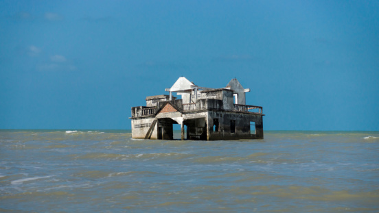 Global warming and monsoon Destroyed houses near the coast, Thailand.