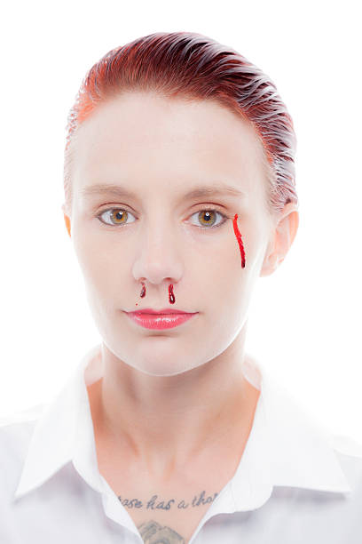 Redhead with her hair gelled back, crying a tear of blood. Isolated on a pure white background.