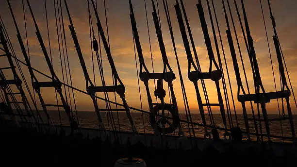 sunset through the rigging of an old sailing ship