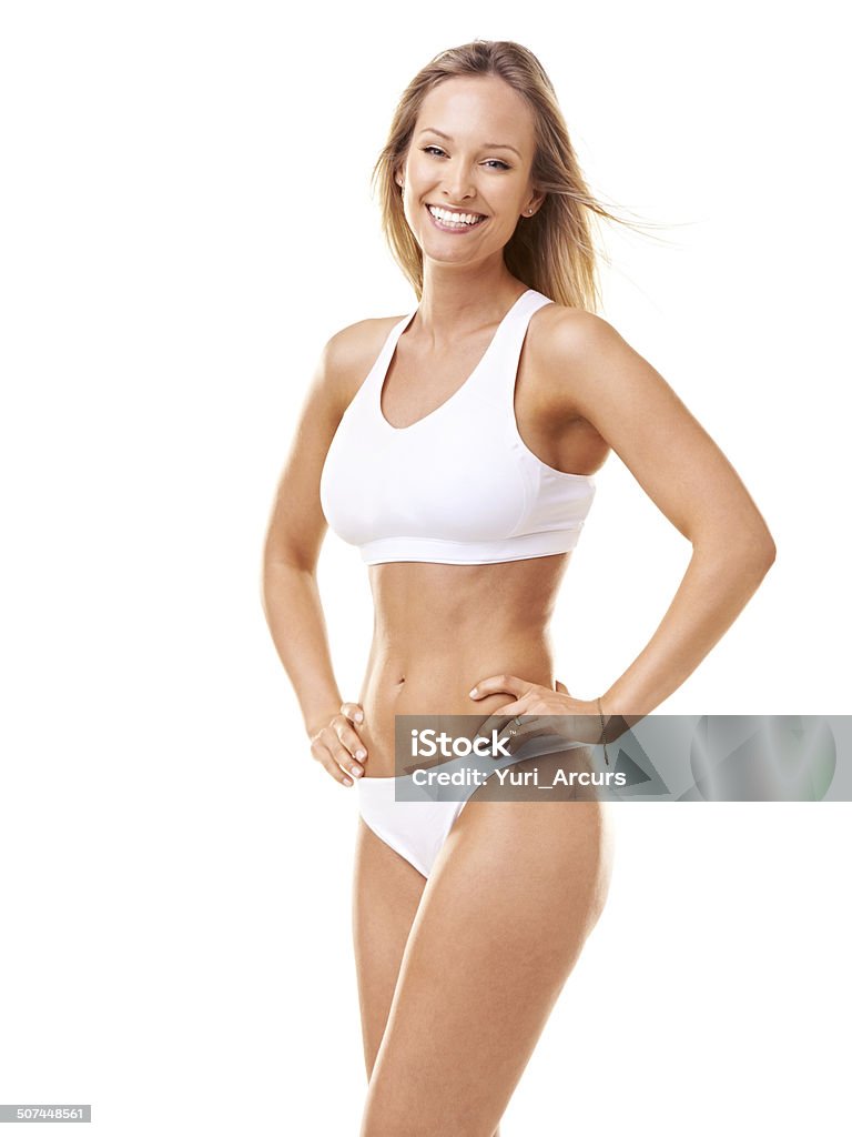 The fresh face of fitness and vitality A gorgeous young woman in sporty lingerie posing with hands on her hips against a white background One Woman Only Stock Photo