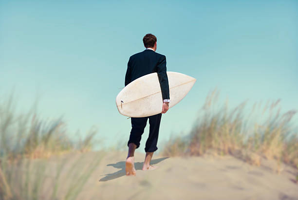 Businessman with Surfboard Going to the Beach