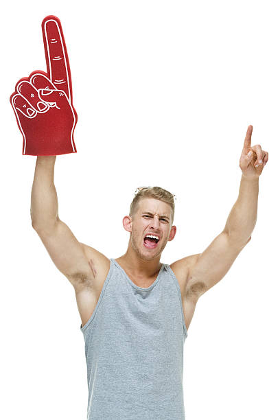 istock Muscular man holding foam finger & cheering 507450019