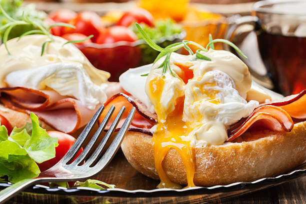 Eggs Benedict on toasted muffins with ham stock photo