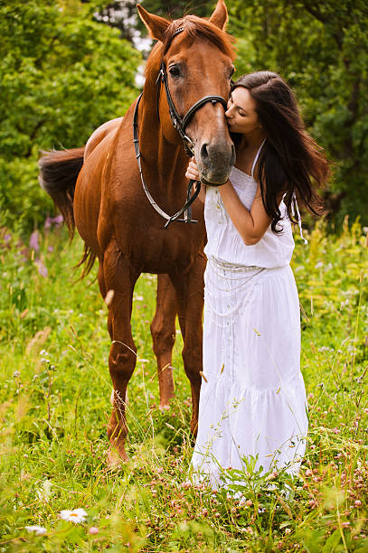 istock young woman with horse 507452427