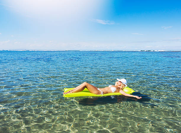 istock Woman relaxing and floating in the ocean 507452551