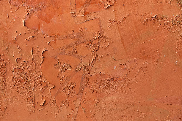 istock Old terracotta painted stucco wall with chipped paint. Backgroun 507453208