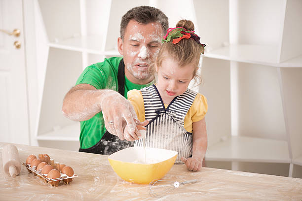 istock Father and daughter cooking 507454193