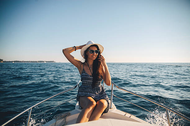 istock Young brunette on the boat enjoying summertime 507455488