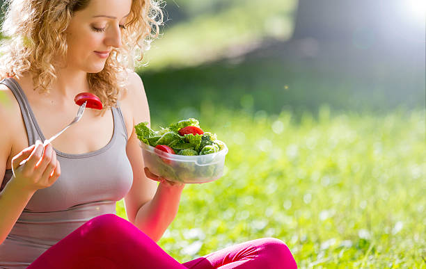 istock Young fit woman having snack in park 507455706
