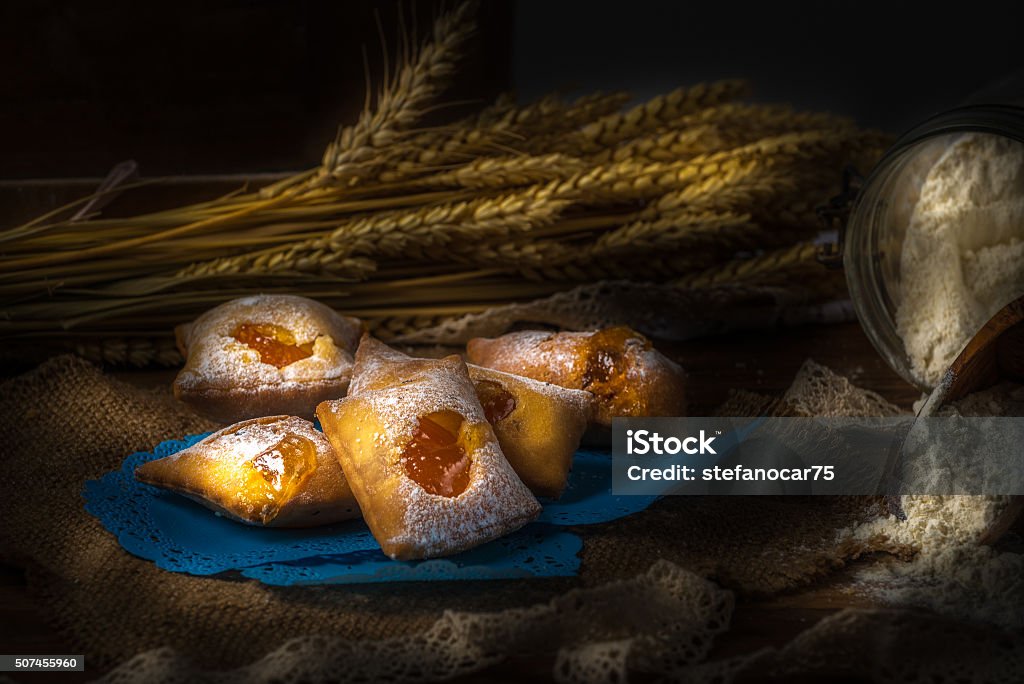 italian carnival pastry filled with jam lightpaint italian carnival pastry filled with apricot  jam Backgrounds Stock Photo