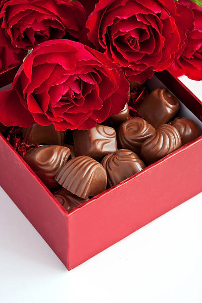 istock Gift box of chocolate truffles with red roses 507456374