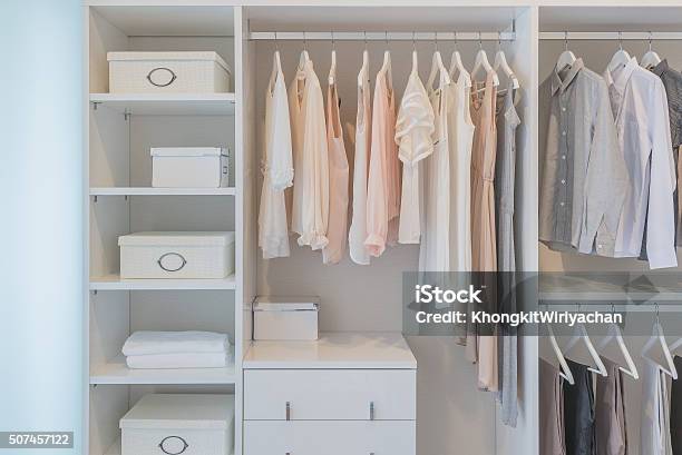 Clothes Hanging On Rail In White Wardrobe Stock Photo - Download Image Now - Closet, Arts Culture and Entertainment, Business