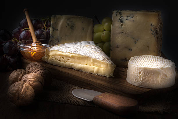 istock wooden board with cheeses, grapes, nuts and honey 507457346