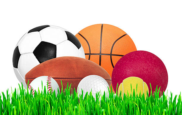 istock Sports balls on green grass isolated on white background 507457452