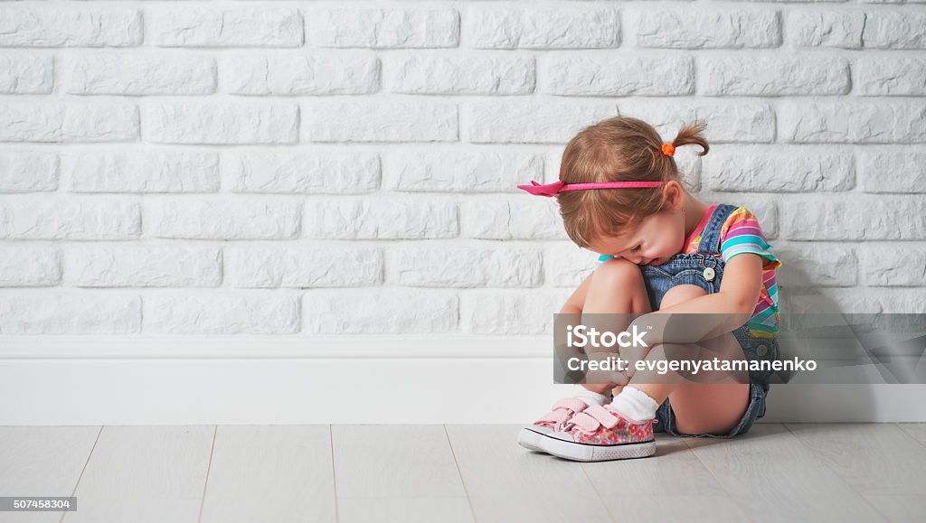 little child girl crying and sad about brick wall little child girl crying and sad about an empty brick wall Crying Stock Photo