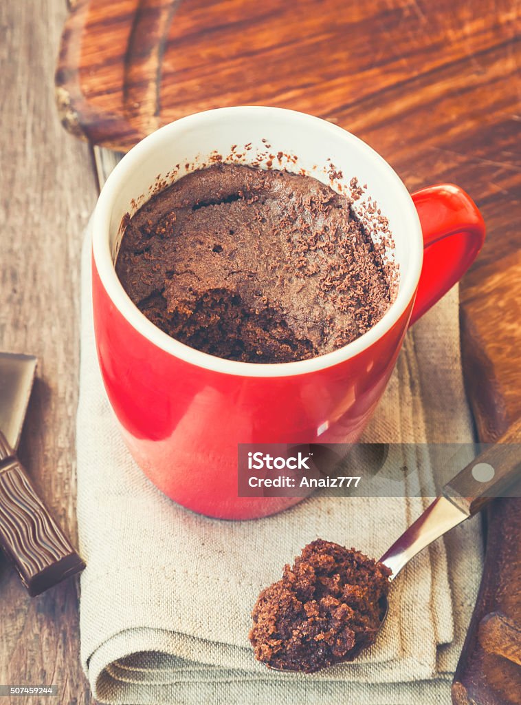 Quick chocolate cake in a mug Chocolate cake in a mug. Vintage toned picture. Mug Stock Photo