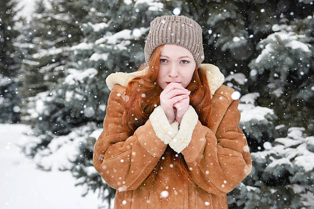 istock Young woman warms hands at winter 507460082