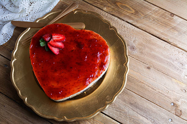 istock Heart shaped cheesecake with raspberry jelly on a gold plate 507462164