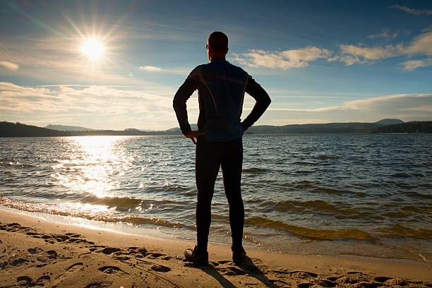 istock Sport active adult man  exercising on beach. Calm water 507473322