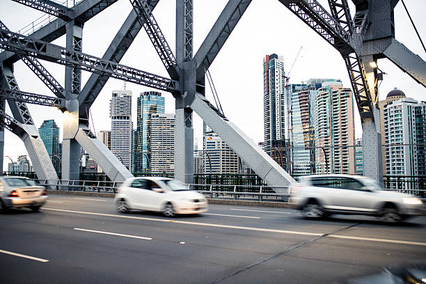 Traffic on Story bridge in Brisbane Story bridge with traffic in Brisbane. City with tall skyscrapers in back. story bridge photos stock pictures, royalty-free photos & images