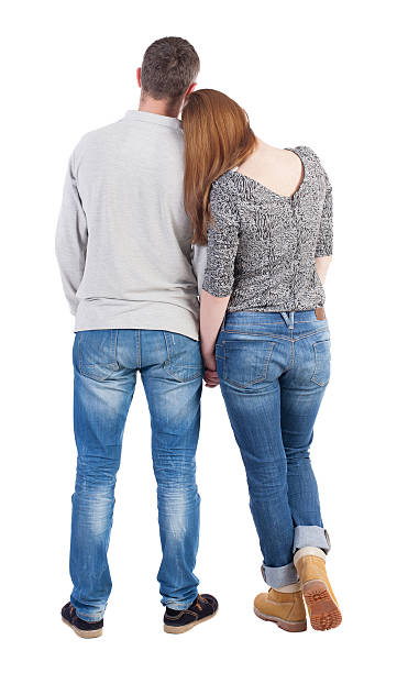 istock Back view of young embracing couple 507473440