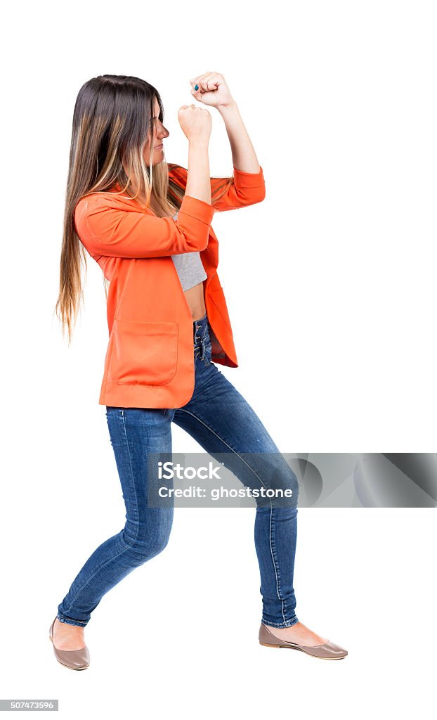 skinny woman funny fights waving his arms and legs skinny woman funny fights waving his arms and legs. Isolated over white background. The girl in the red jacket standing in a boxing pose protecting her face from the blow. Adult Stock Photo