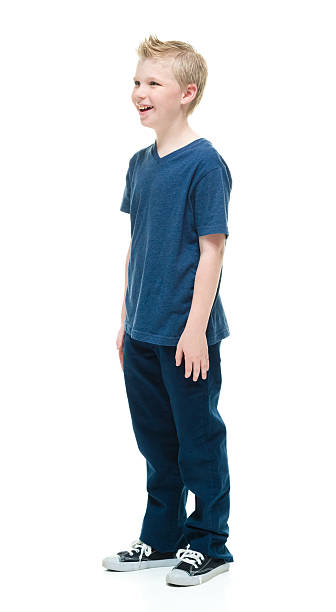 istock Smiling little boy standing and looking away 507474036