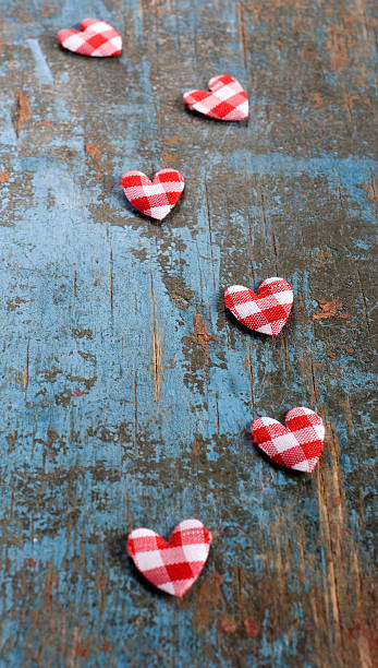 istock Red checkered hearts on the blue wood tray 507474528