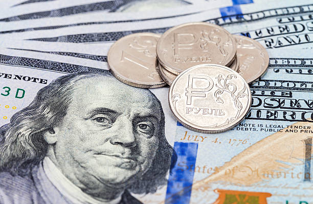 istock Russian rubles coins over dollars banknotes 507474666