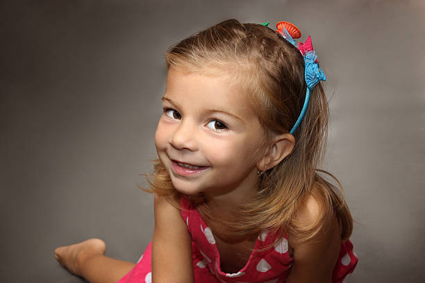 istock the little amusing girl in a red dress 507476492
