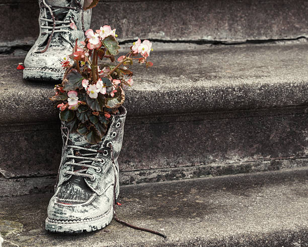 istock Old boots with flowers on stairs 507477438