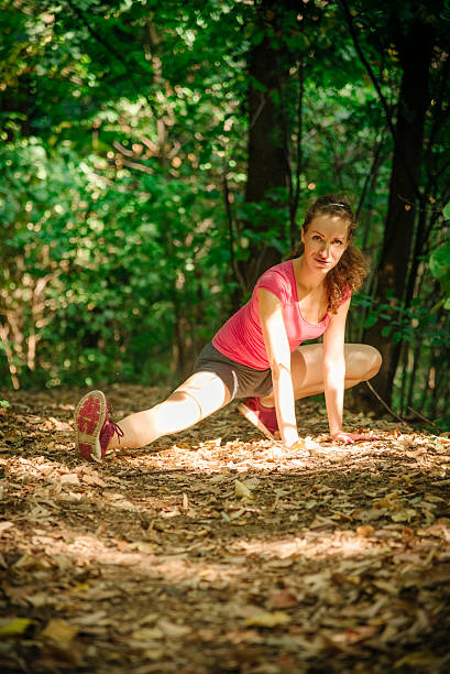 istock Women is stretching in the deep forest woods 507477492