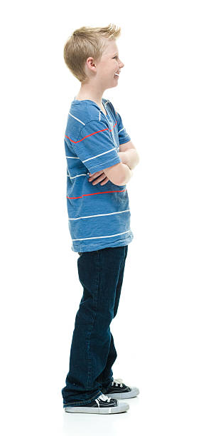 istock Smiling little boy standing with arms crossed 507478504