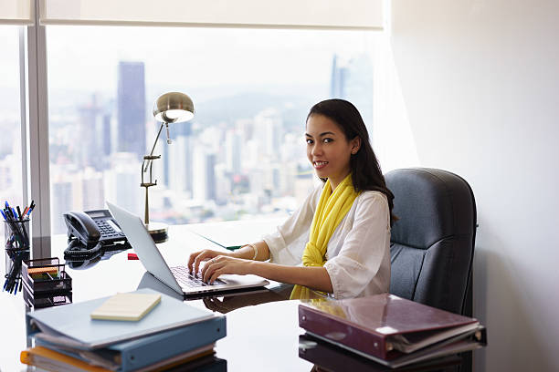 istock Business Woman Assistant Typing On PC And Smiling At Camera 507479022
