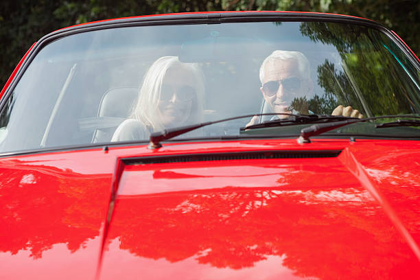 istock Smiling mature couple in red cabriolet 507485905
