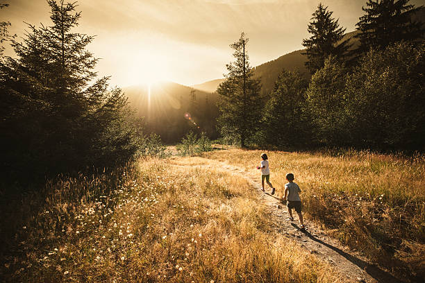 Kids running towards the sun Kids running towards the sun in Olympic National Park. olympic peninsula photos stock pictures, royalty-free photos & images