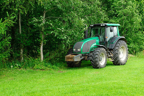 tractor in the wood the green tractor stopped in the field of near wood farmer tractor iowa farm stock pictures, royalty-free photos & images