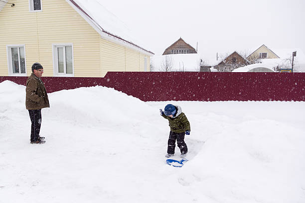 istock little boy riding on a snowy hill 507492092