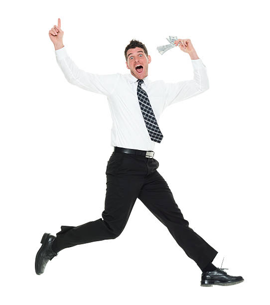 istock Excited businessman jumping with money 507492154