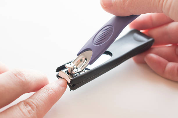 istock Close up of hand with nail clipper 507492685