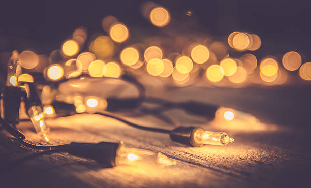 istock christmas light decor on wood background , color filter vintage tone 507492880