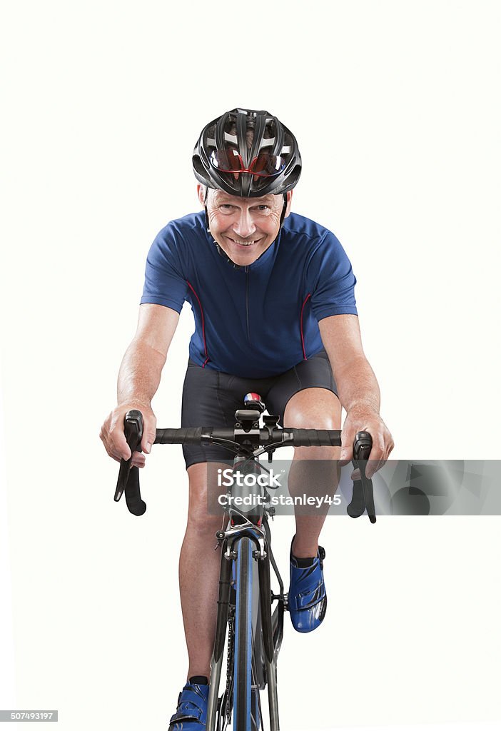 Mature Adult Bicycle Rider Active Senior Male Cyclist pedaling a racing bike in the studio. Cycling Stock Photo