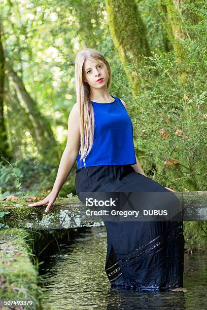 Beautiful Woman Sitting On Bridge Above Stream Stock Photo - Download Image Now - Only Women, Sitting, Skirt