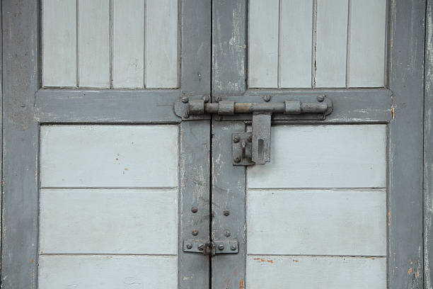 Grey wooden door with a bolt Grey wooden door with a bolt unbolted stock pictures, royalty-free photos & images