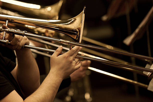 sheet music on a stand and a trombone player.