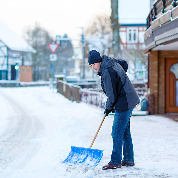 istock Man with snow shovel cleans sidewalks in winter 507497484