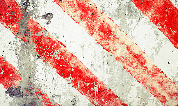 istock Striped red and white lines  over old grungy concrete wall 507497800