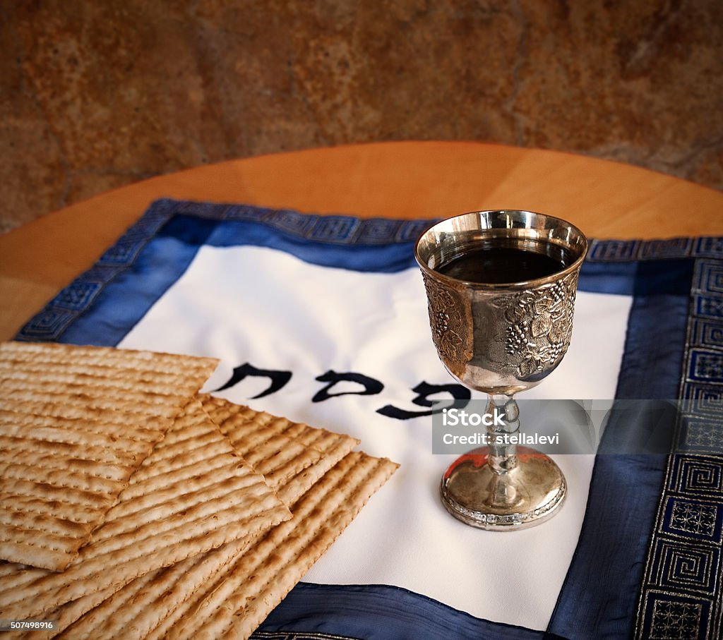 Passover Matzo and a wine in a Kiddush cup with the words PESACH  Passover Stock Photo